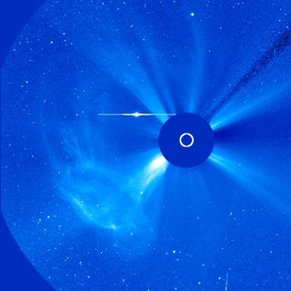 A broadly widening cloud of particles, observed by SOHO's C3 coronagraph, rushed away from the Sun as a coronal mass ejection (CME) erupted over about 12 hours (June 14, 2011). Data from the Solar Dynamics Observatory shows an eruptive prominence breaking away from the Sun about where the event originated. While the originating event did not appear to be substantial, the particle cloud was pretty impressive. The bright circle with an extending horizontal line (above and left of the blue occulting disk) is a distortion caused by the brightness of planet Mercury.
