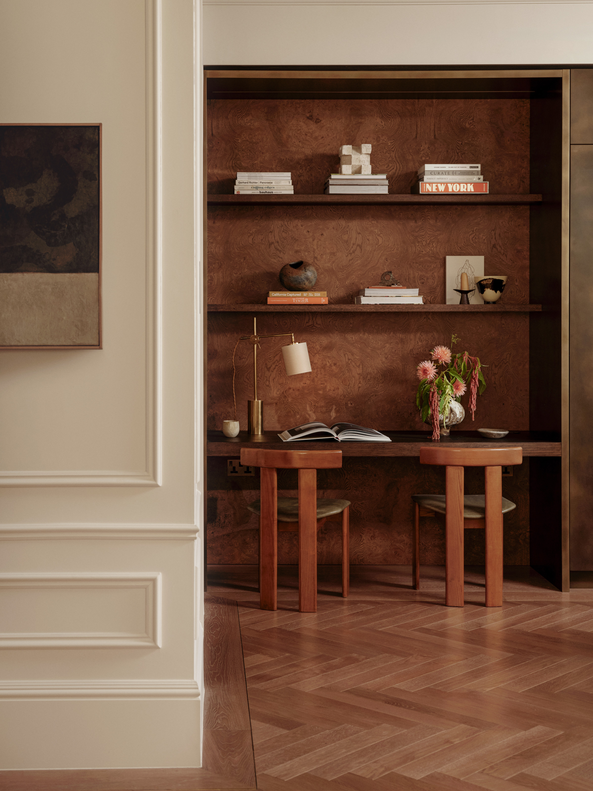Study area with built-in shelving in a nook decorated with burl wood