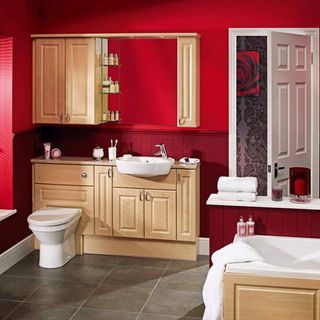 red bathroom with cabinet and drawers