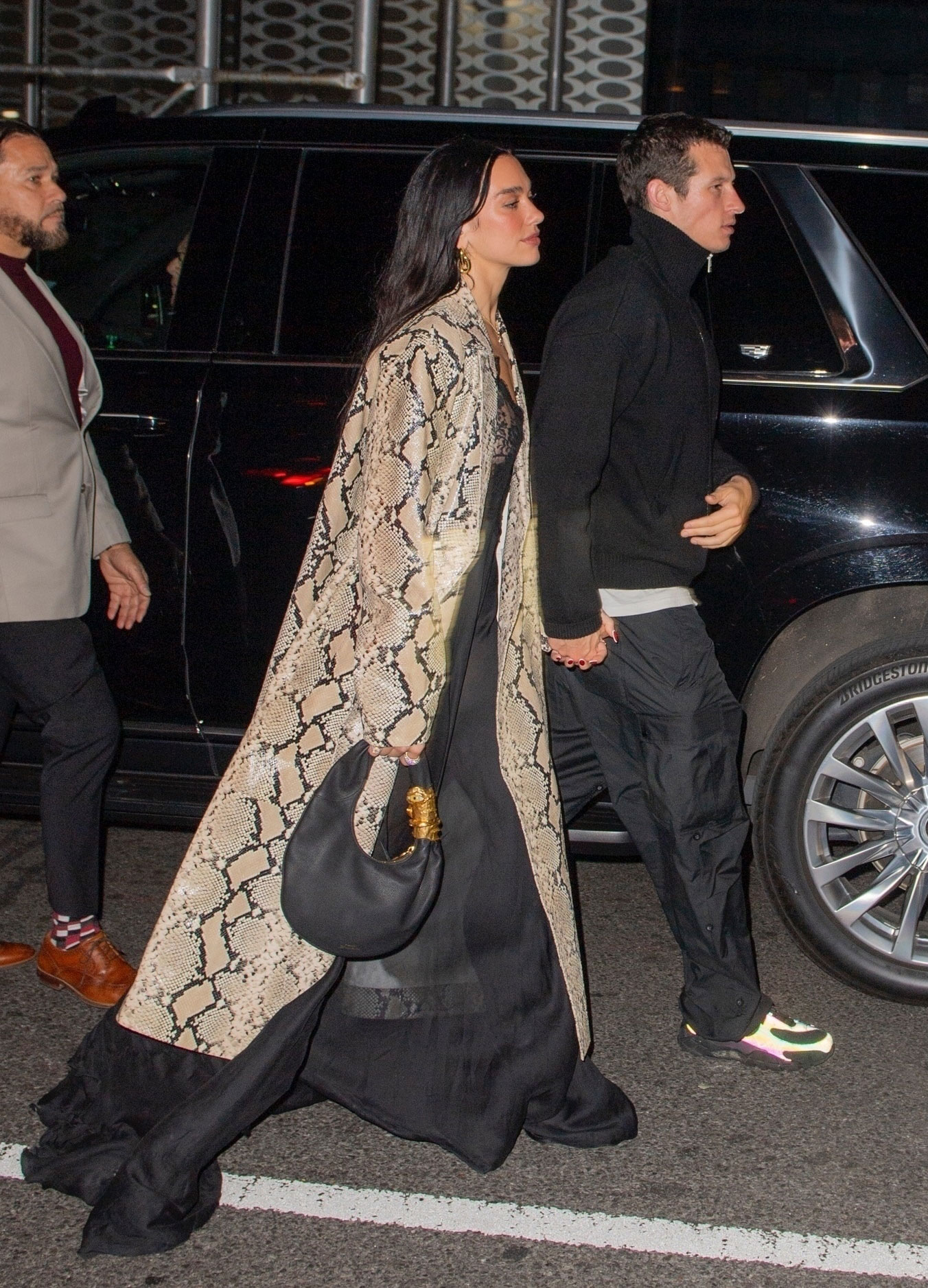 Dua Lipa wears a snake print coat