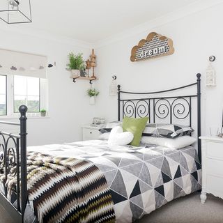 master bedroom with white walls and white bedside table