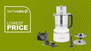 A green background with Tech Radar Lowest Price written in white, and a KitchenAid 13 Cup Food Processor and accessories pictured on the right.