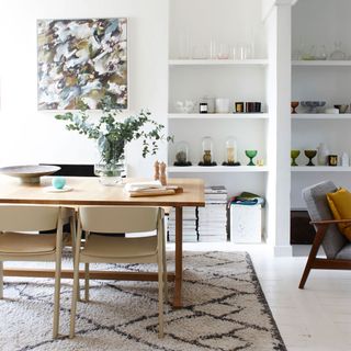 white dining room with modern furniture and berber rug