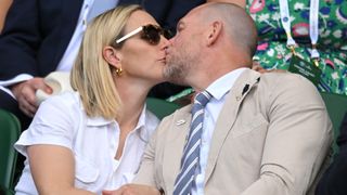 Mike and Zara Tindall at Wimbledon: LONDON, ENGLAND - JUNE 28: Zara Phillips and Mike Tindall kiss as they attend Day Two of Wimbledon 2022 at All England Lawn Tennis and Croquet Club on June 28, 2022 in London, England.