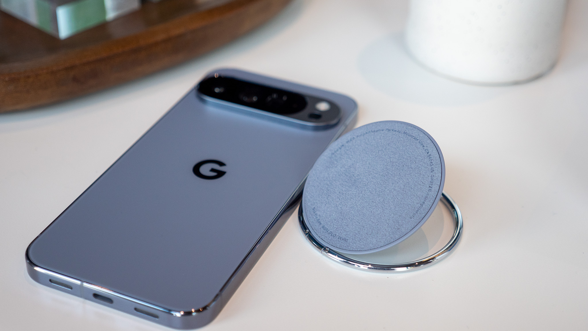 A Google Pixelsnap ring attached to the back of the Google Pixel 10 Pro XL via Qi2 magnets