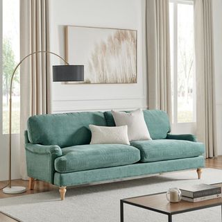 Sea green sofa in a neutral living room