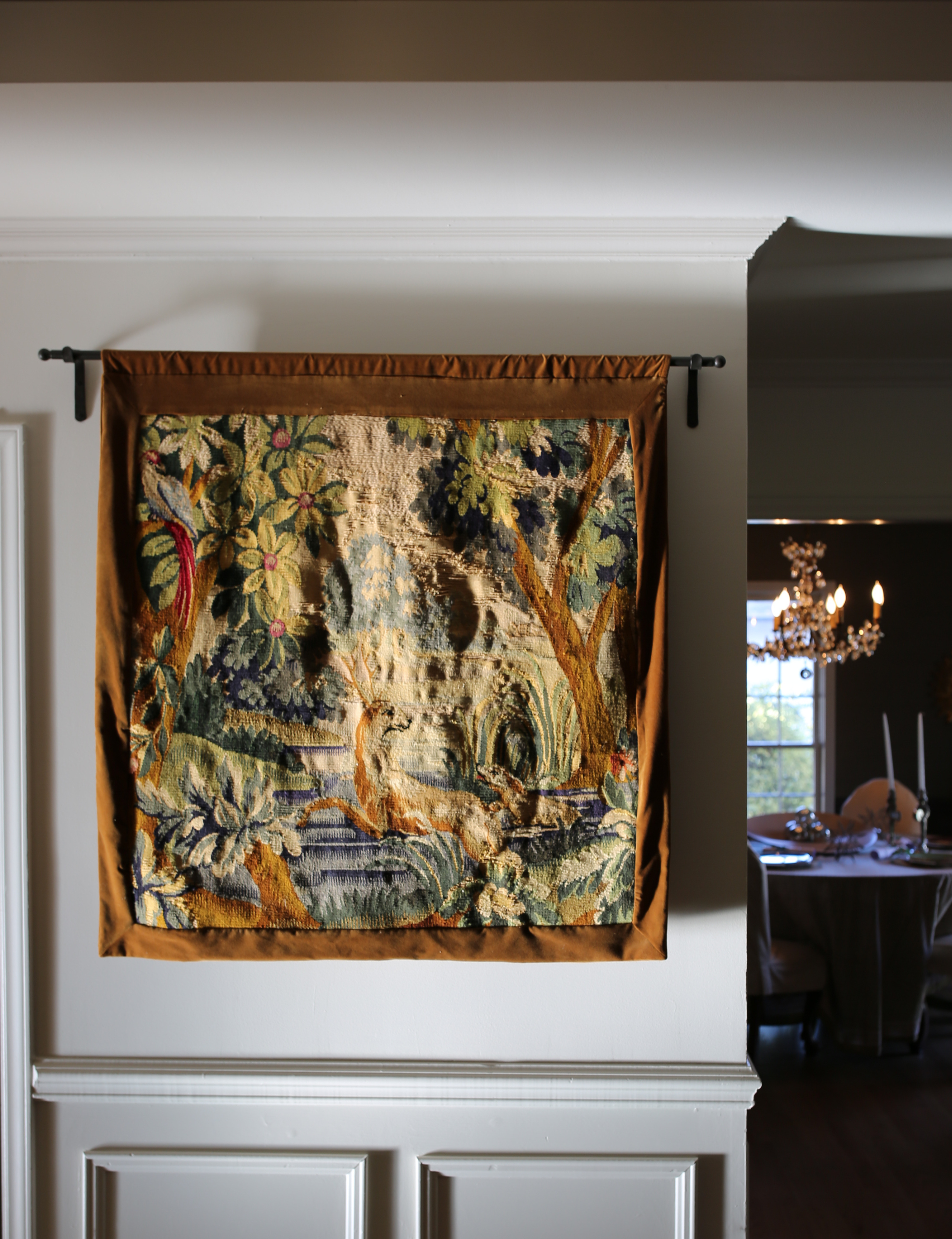 Antique wall tapestry photographed in an antique-inspired entryway area