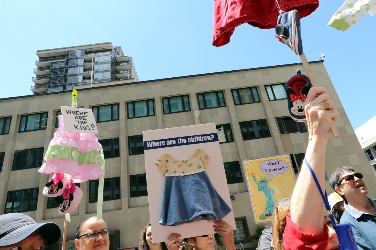 Protest signs about detained migrant children.