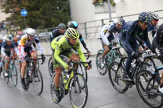 The peloton powers up the climb