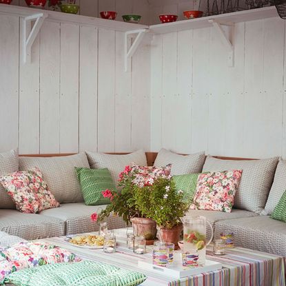 room with white walls and sofaset with cushions