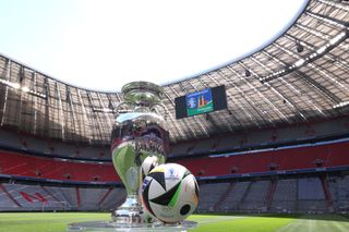 The UEFA EURO 2024 Winners Trophy is pictured with the official adidas matchball Fußballliebe in the Allianz Arena during the UEFA Euro 2024 Trophy Tour on May 13, 2024 in Munich, Germany. (Photo by Alexander Hassenstein - UEFA/UEFA via Getty Images)
