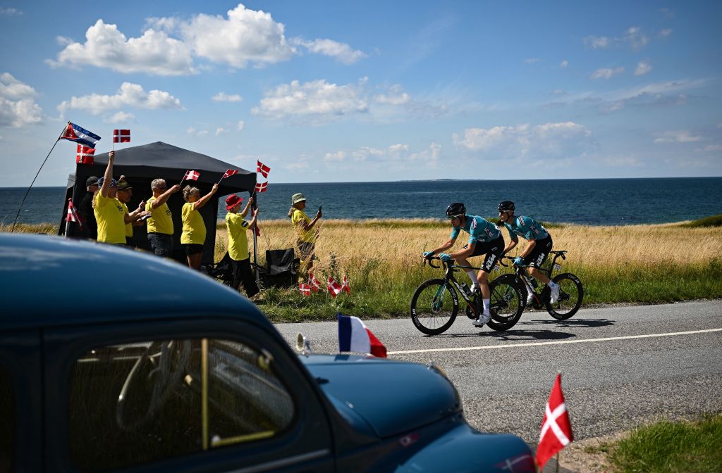 BB HotelsKTM teams French rider Cyril Barthe L and BB HotelsKTM teams French rider Pierre Rolland R cycle in a breakaway past a vintage car during the 2nd stage of the 109th edition of the Tour de France cycling race 2022 km between Roskilde and Nyborg in Denmark on July 2 2022 Photo by Marco BERTORELLO AFP Photo by MARCO BERTORELLOAFP via Getty Images