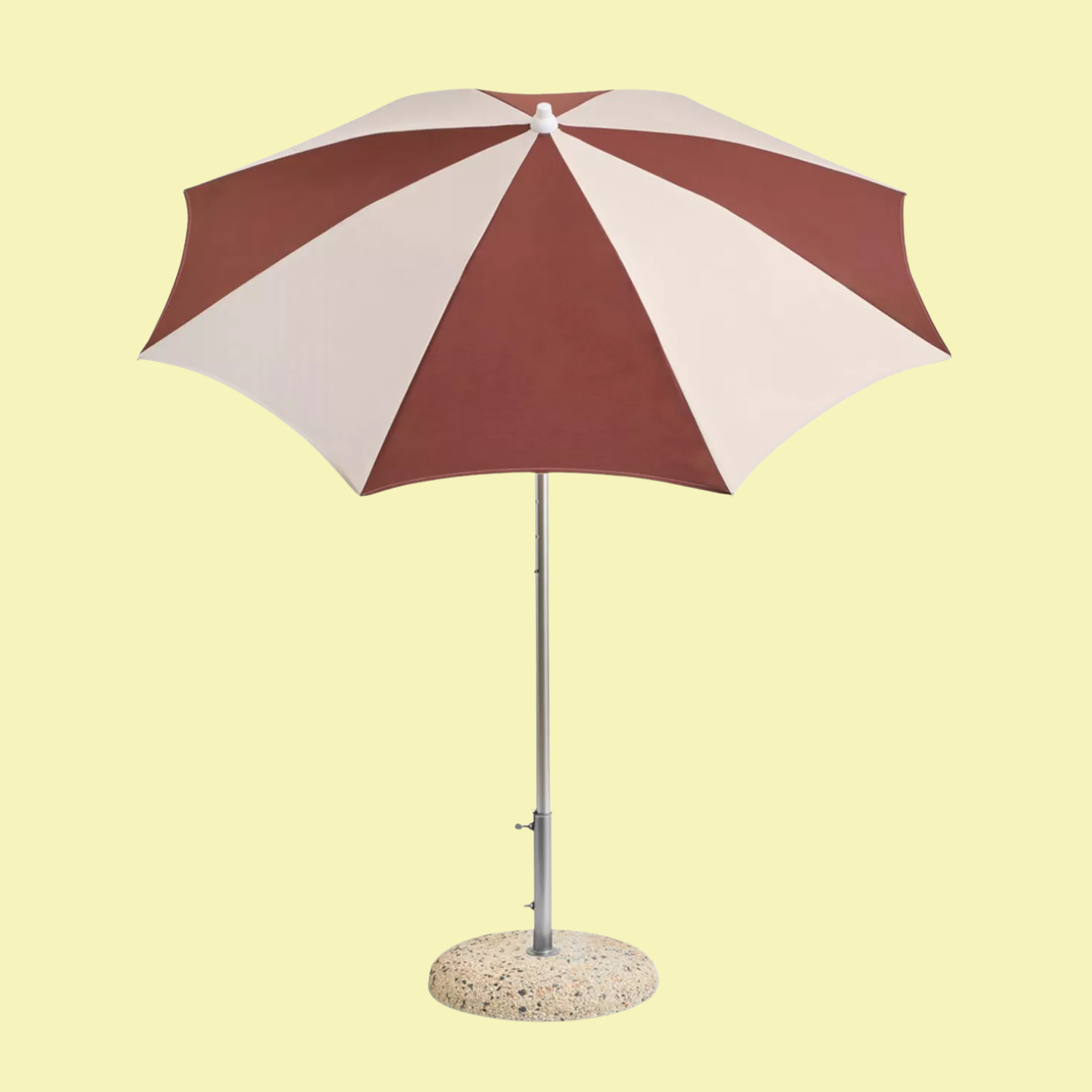 A burgundy and off-white parasol on a terrazzo base