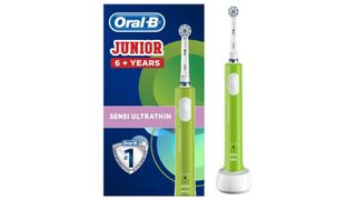 lime green electric toothbrush next to its dark blue packaging as part of best electric toothbrushes for kids roundup