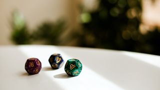 dice with astrology signs on a blurred background with greenery