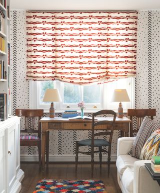 desk with patterned wallpaper and patterned blind