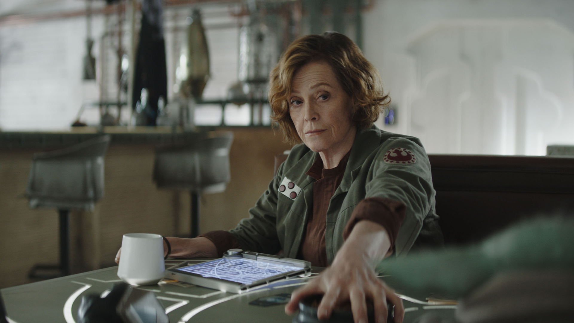 Colonel Ward stops Grogu from stealing her snacks in The Mandalorian and Grogu