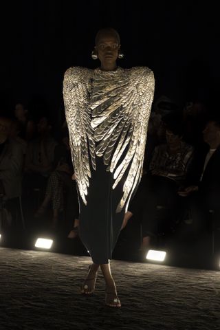 Schiaparelli Haute COuture A/W 2024 showing model in feathered cape on runway
