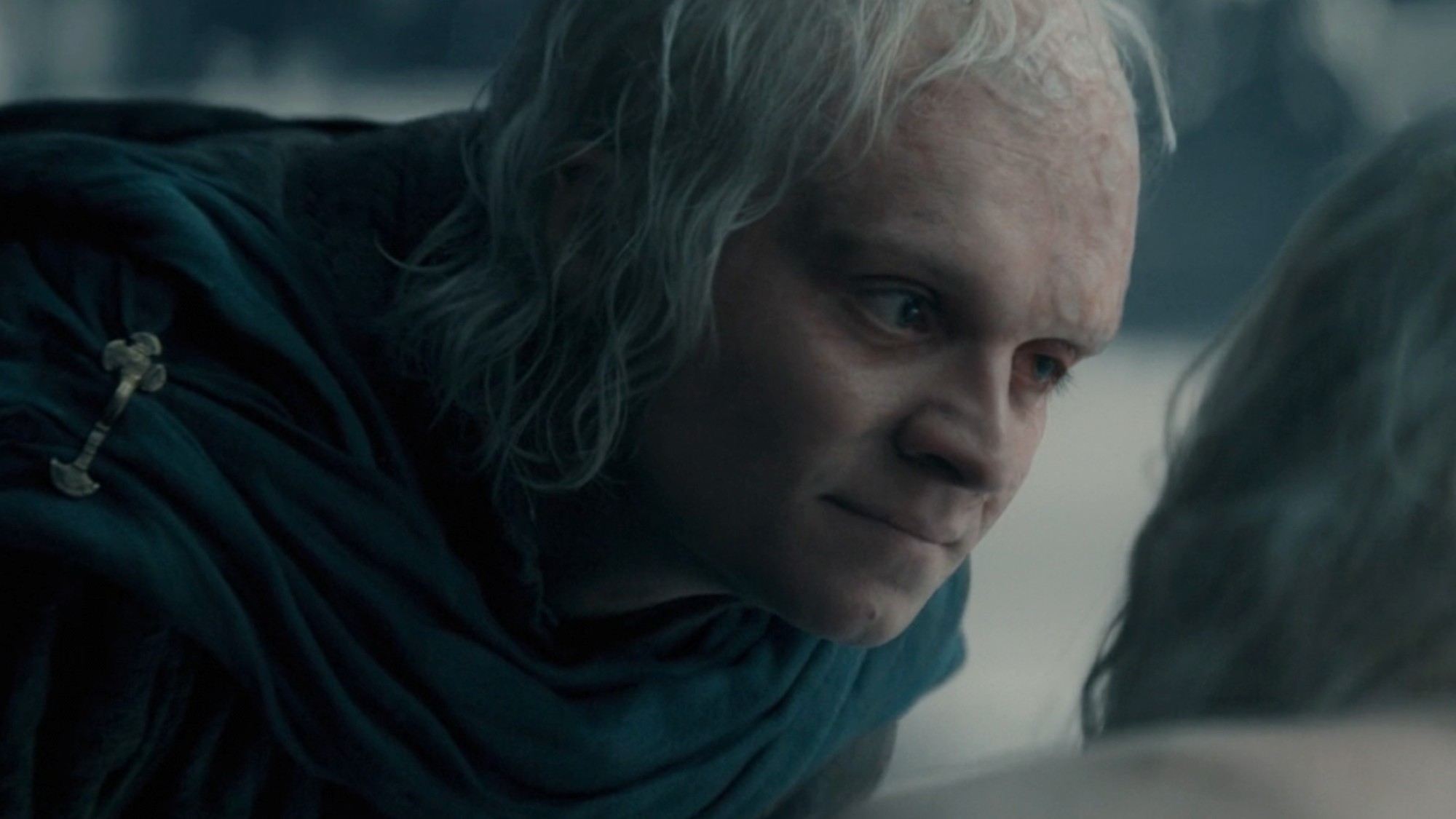 Tom Glynn-Carney as Aegon bending down and looking at Aemond (who is out of frame). 