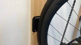 Close up of wheel on Lezyne CNC Alloy Wheel Hook plate on wall