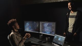 Two videographers chatting next to HP workstations