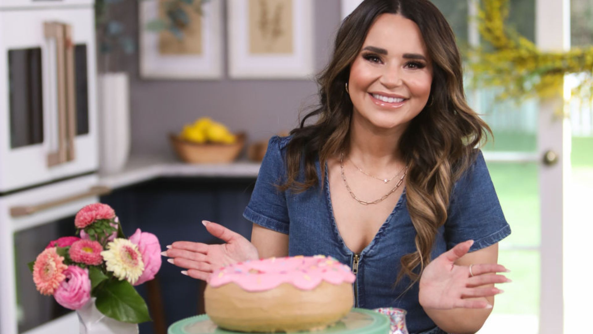 Rosanna Pansino in front of a giant doughnut
