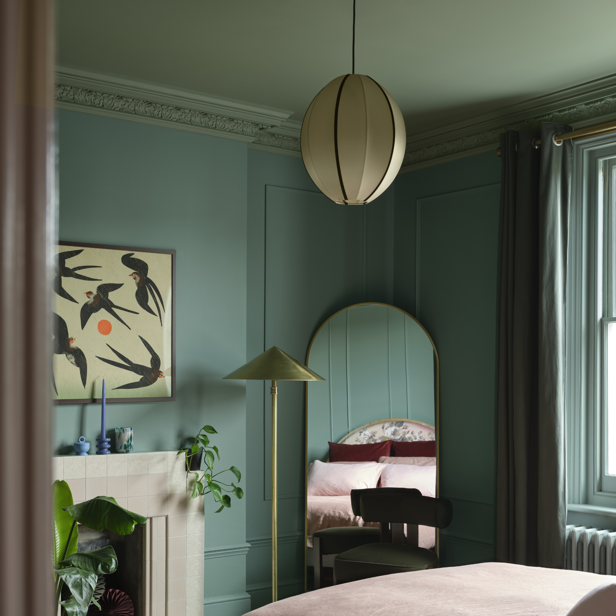 Bedroom which has a colour capping scheme that uses shades of green.