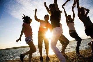 Happy dancers on a beach.