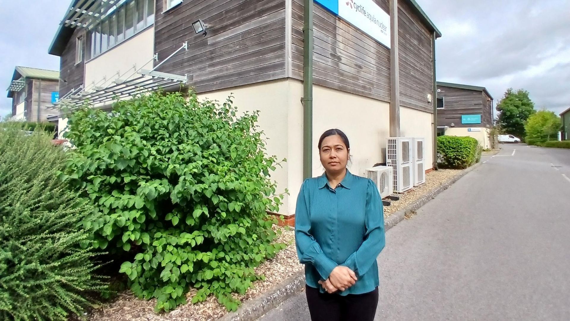 Renu Amin standing by her new workplace