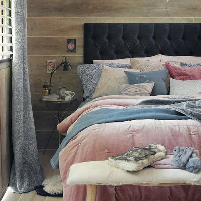 bedroom with wooden flooring and cushions