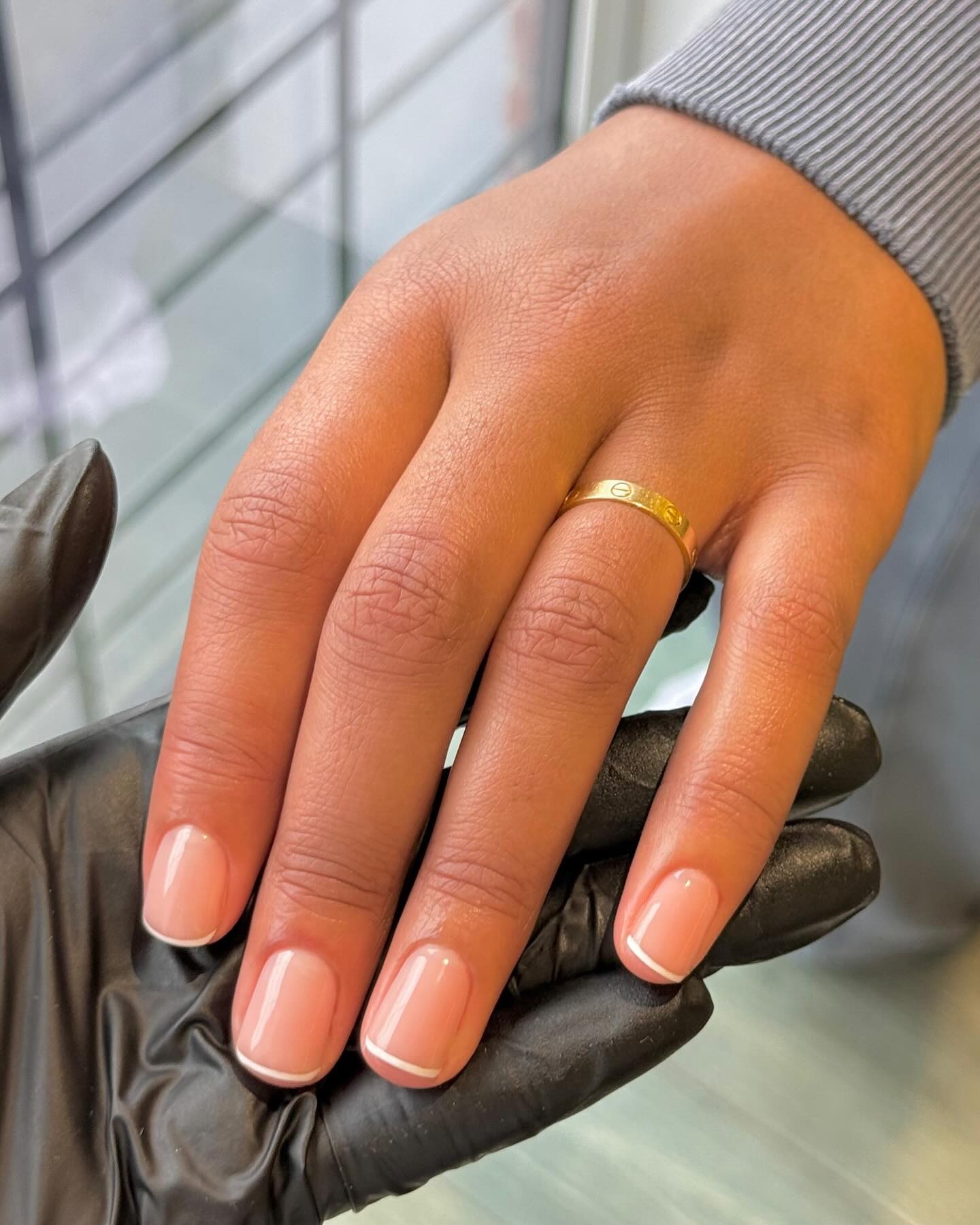 A short, square, micro French tip manicure