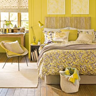 yellow bedroom with wooden floor and floral bed