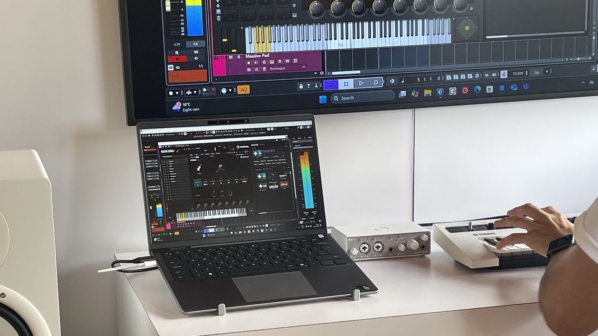 A musician shows off a Cubase digital audio workstation setup running natively on a Snapdragon X Elite-powered Copilot Plus laptop