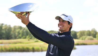 Matteo Manassero holds a trophy aloft