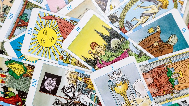 woman with tarot cards in the air