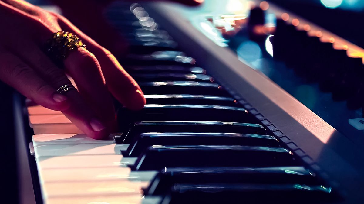 Close up of hands playing one of the best electronic keyboards 