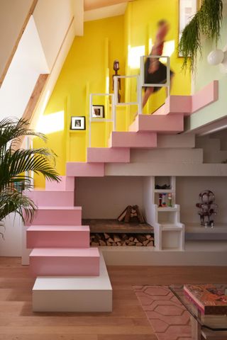 Sun Dial Apartment by Manuelle Gautrand - a pink staircase which leads up to an upper level with yellow walls.
