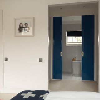 bathroom with white wall and blue sliding door