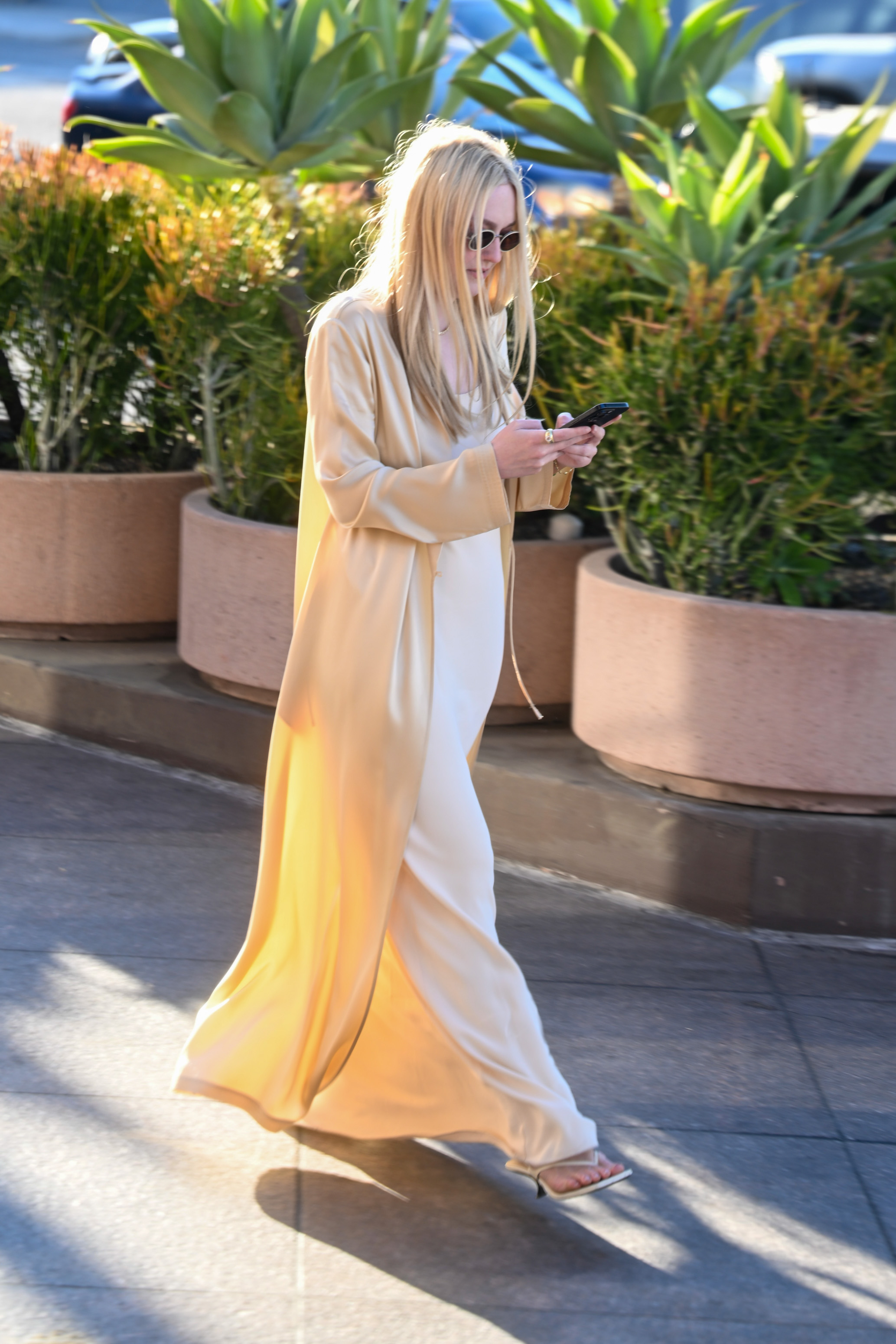 Dakota Fanning styled a slip dress and a matching silky robe with the heeled flip-flops trend