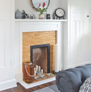 tiled fireplace in with matching tiles on the inset and hearth in a white living room