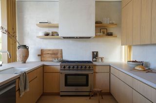 a modern small kitchen with wood cabinets