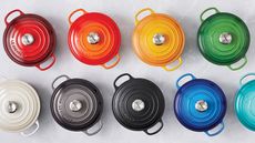 le creuset cast iron pots in red, orange, yellow, green, white, silver, black, dark blue, and light blue