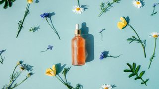 Vitamin C serum pictured on a blue backdrop