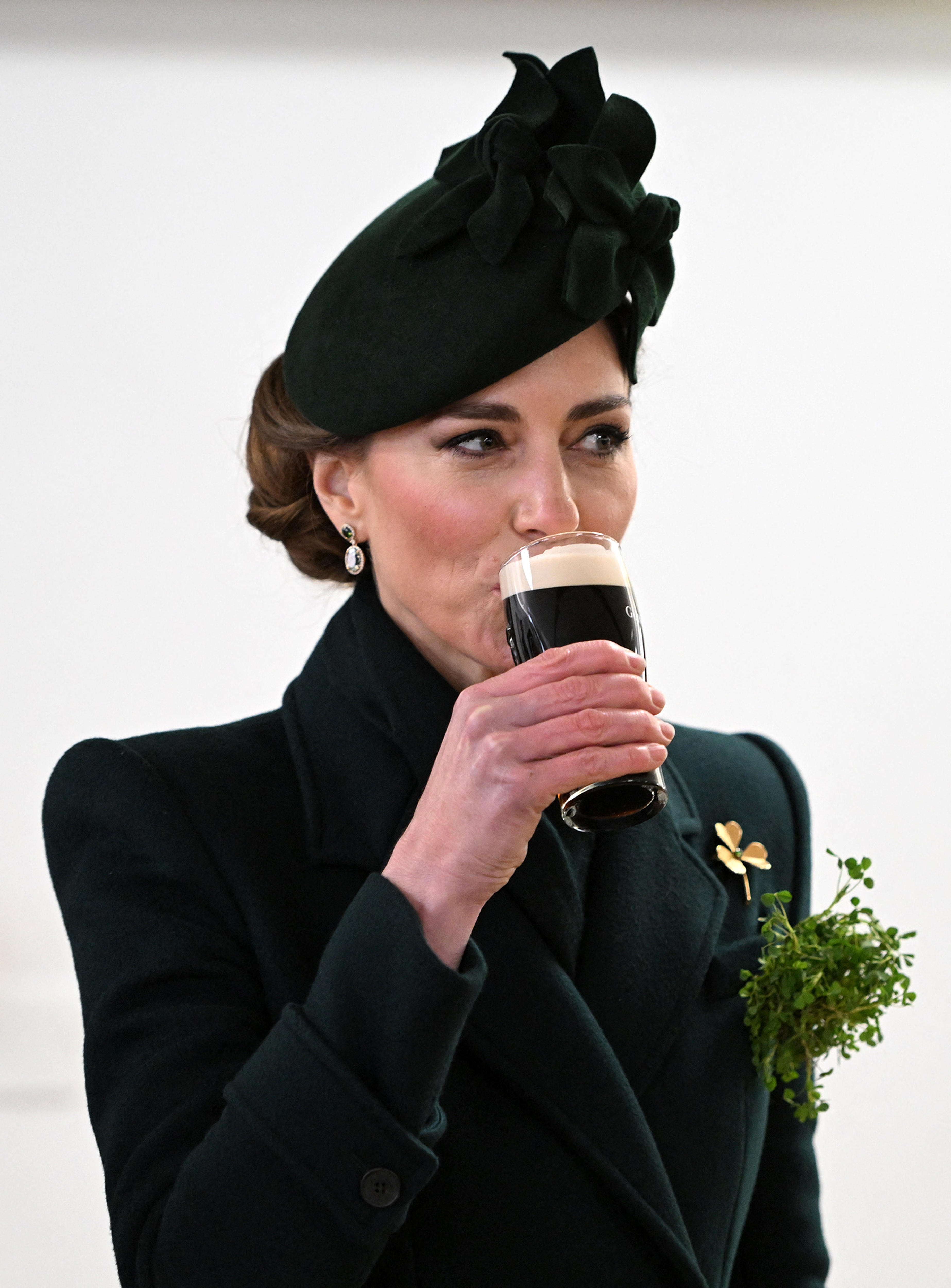 Britain's Catherine, Princess of Wales takes a sip of Guinness during her visit to Wellington Barracks, in central London, on March 17, 2025, where she met with meet with Irish Guards for their St Patrick's Day Parade. (Photo by Eddie Mulholland / POOL / AFP)