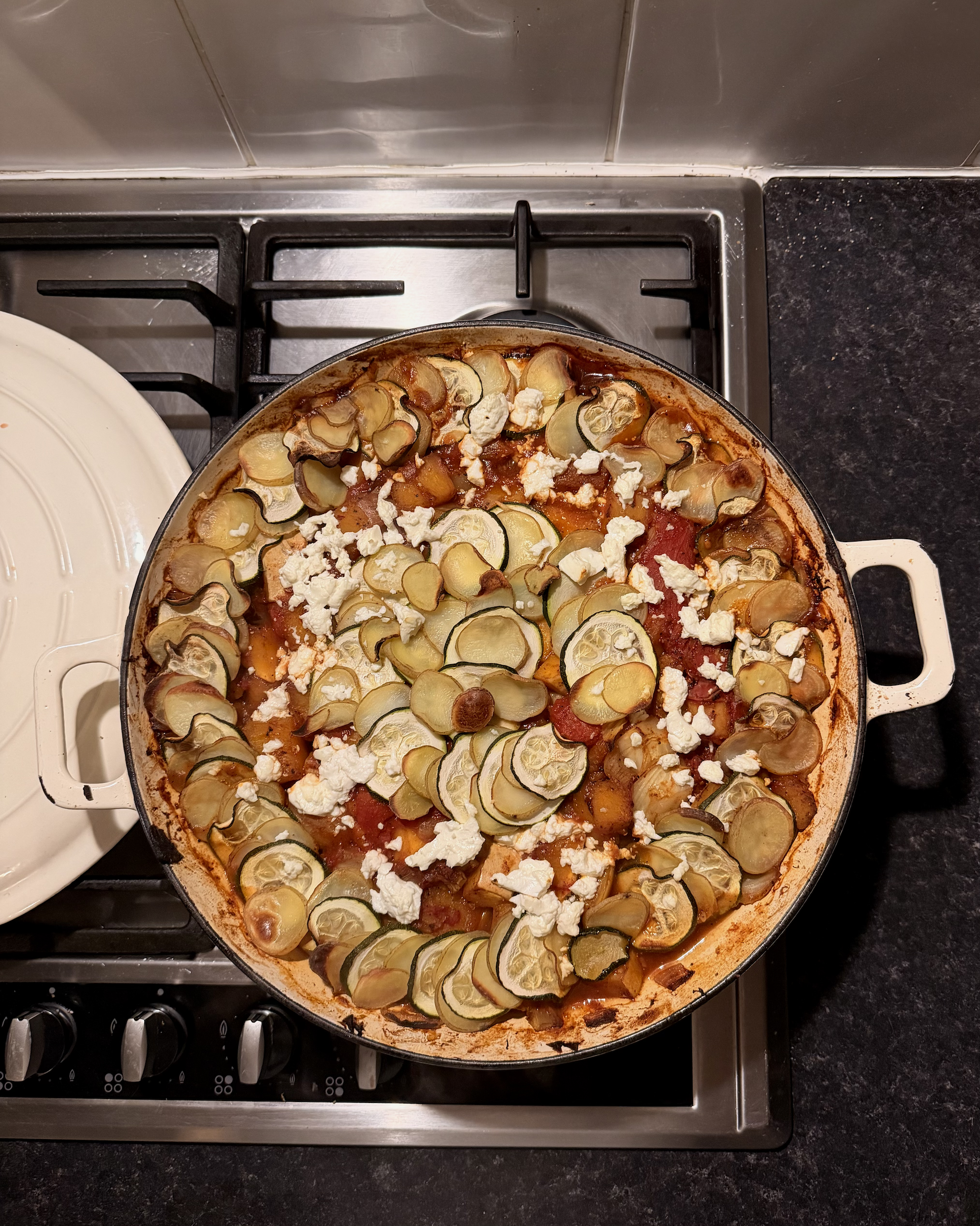 a large pan of vegetable casserole on a dark countertop