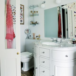 bathroom with commode and mirror