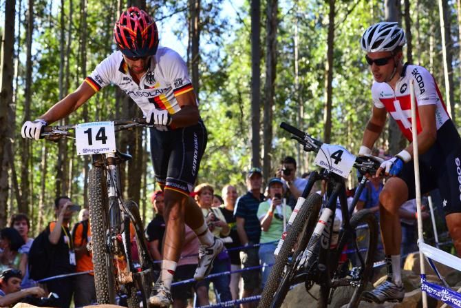 Germany's Mauel Fumic (left) put aside a clash with Switzerland's Fabian Giger to power back and claim the silver medal in the elite men's cross country