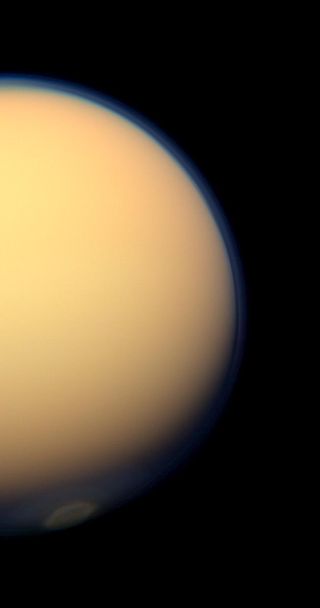 This day-side photo of Titan taken by the Cassini spacecraft shows a buildup of haze over the Saturn moon's south pole (bottom).