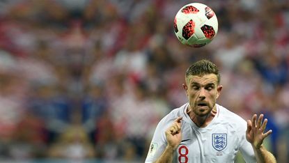 Jordan Henderson heads the ball