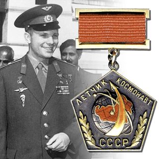 The first device to signify that the wearer had flown into space, the Pilot-Cosmonaut of the USSR badge, was awarded to cosmonaut Yuri Gagarin in April 1961.